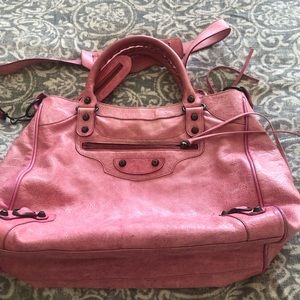 Balenciaga city bag in pale pink with crossbody strap.